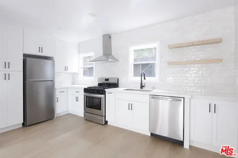 a kitchen with white cabinets and white appliances