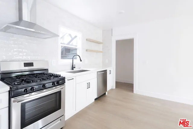 a kitchen with a stove and a sink