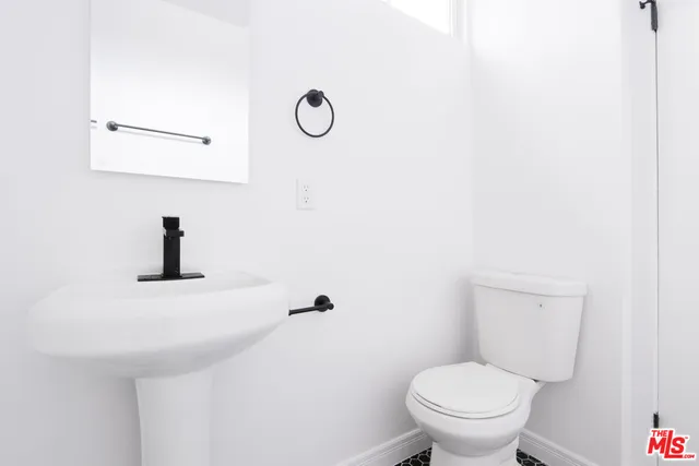 a bathroom with a toilet and a sink
