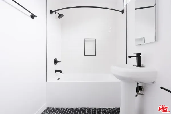 a bathroom with a shower and a sink