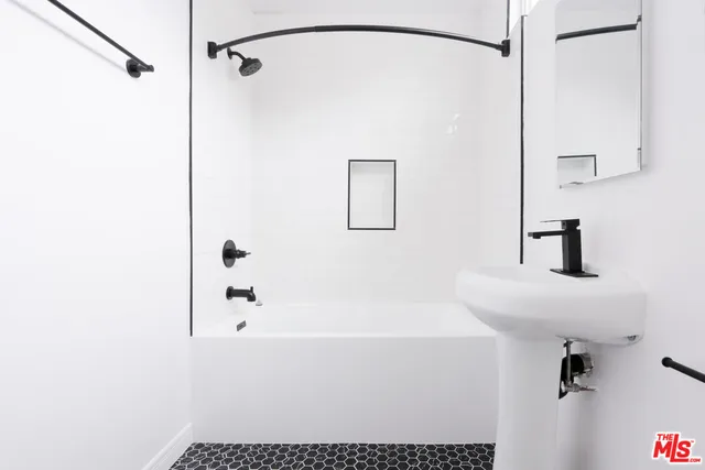 a bathroom with a shower and a sink