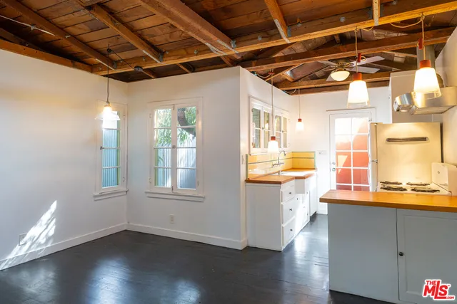 a view of a kitchen with a dishwasher and wooden cabinets