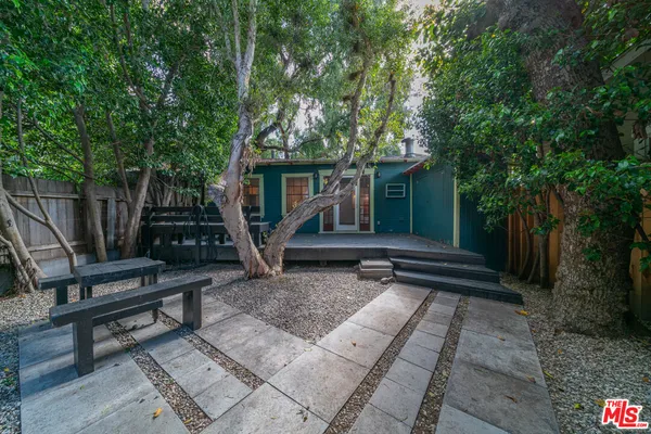 a view of a house with backyard and sitting area