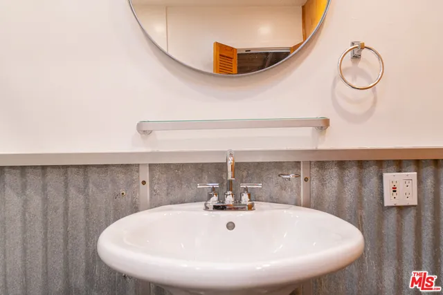 a bathroom with a sink a mirror and shower
