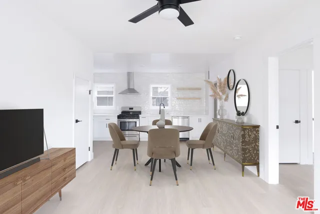 a dining room with furniture and a flat screen tv