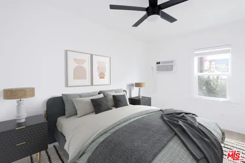 a bedroom with a bed and window