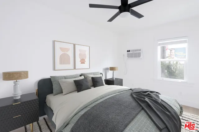 a bedroom with a bed and window