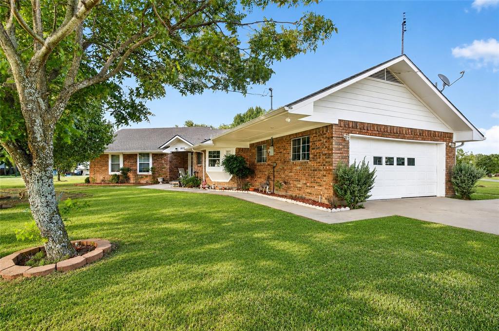 1612 Whitemound Road Sherman, TX 75090 - Photo 2 of 28 Brick exterior with white trim, featuring an attached garage
