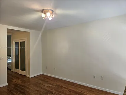 a view of a chandelier fan and hardwood floor