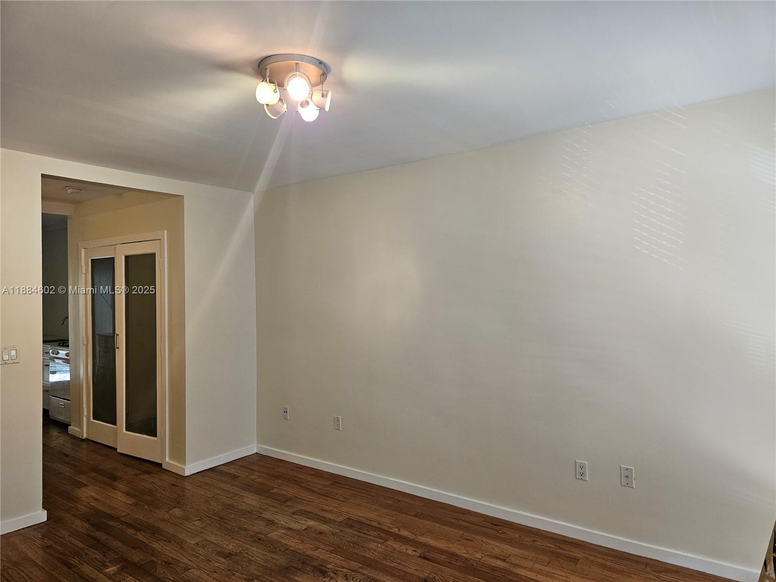 745 13th Street, Unit 16 Miami Beach, FL 33139 - Photo 11 of 27 a view of a chandelier fan and hardwood floor