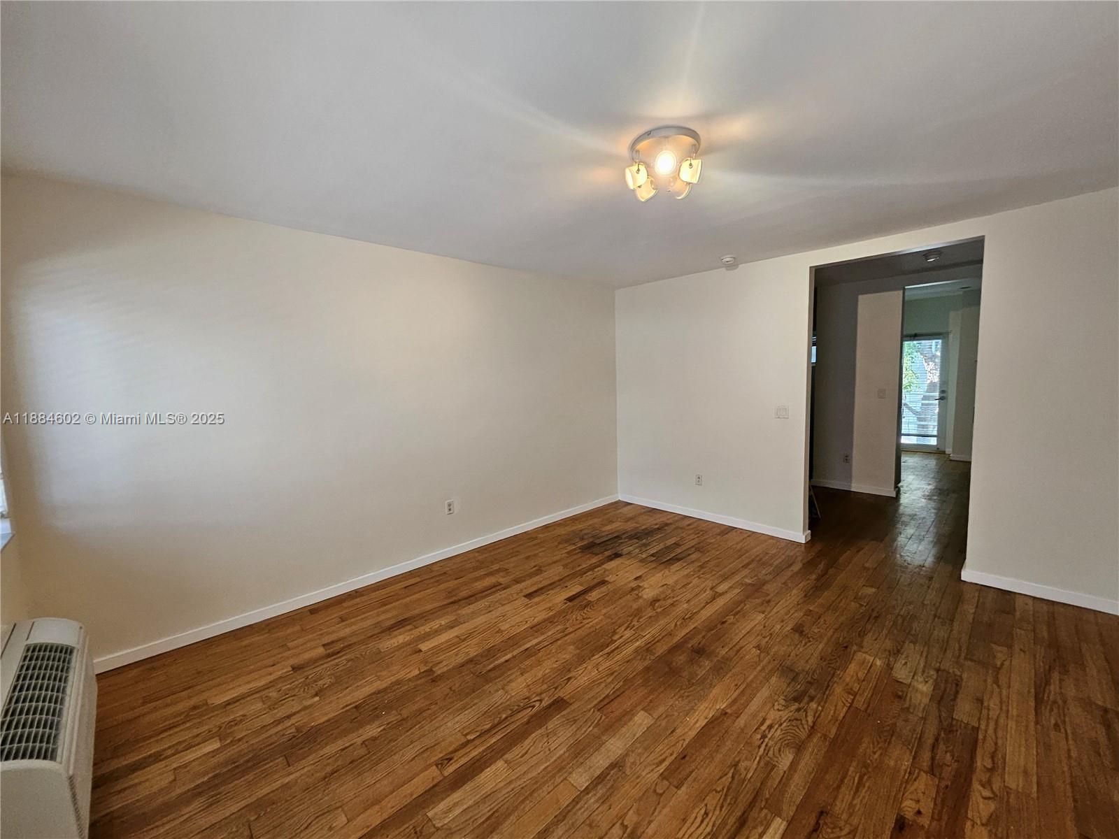 745 13th Street, Unit 16 Miami Beach, FL 33139 - Photo 14 of 27 a view of an empty room with wooden floor and a window