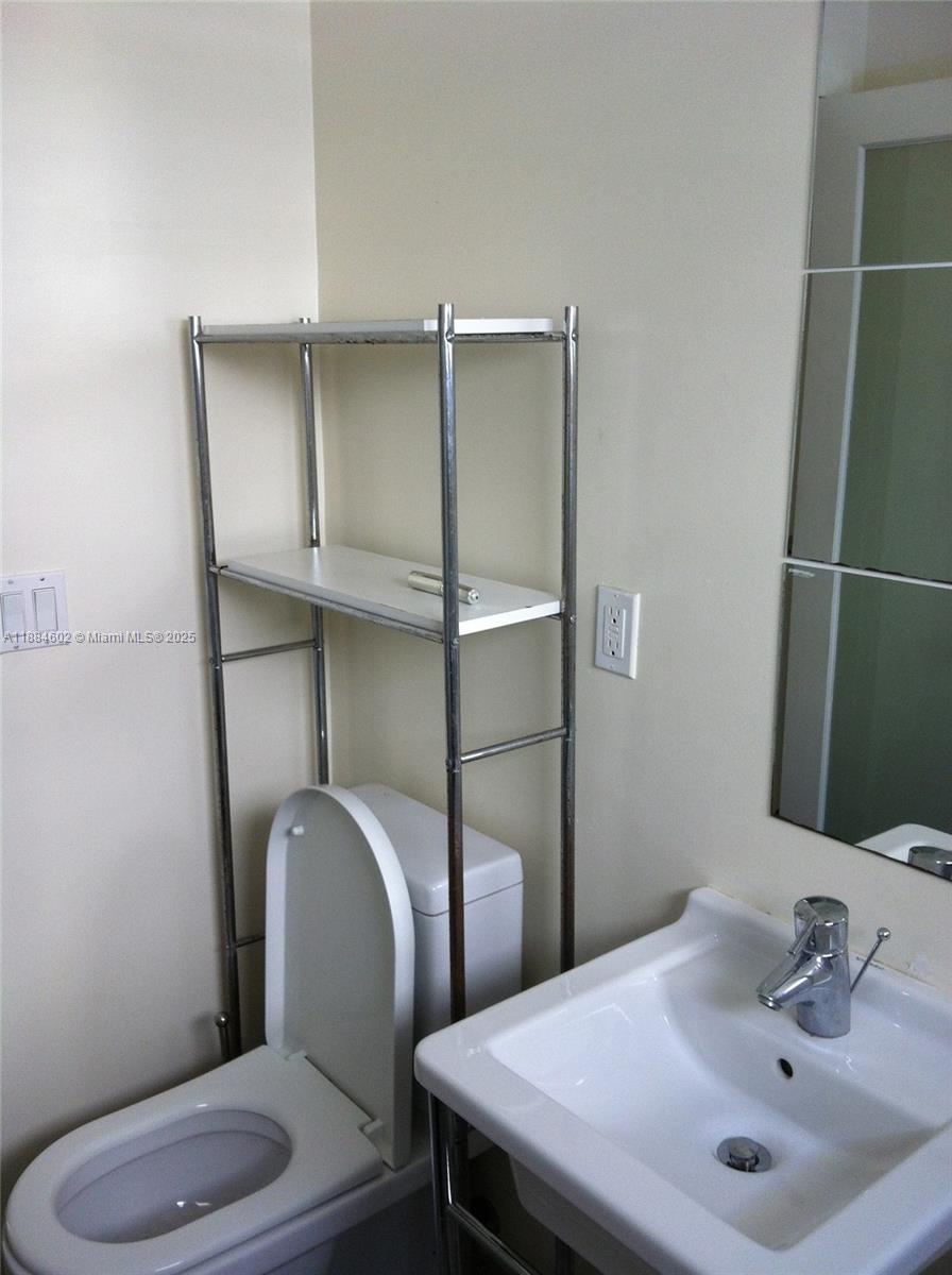 745 13th Street, Unit 16 Miami Beach, FL 33139 - Photo 16 of 27 a bathroom with a sink toilet and mirror