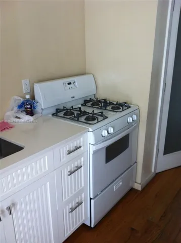 a kitchen with a sink a refrigerator and a stove