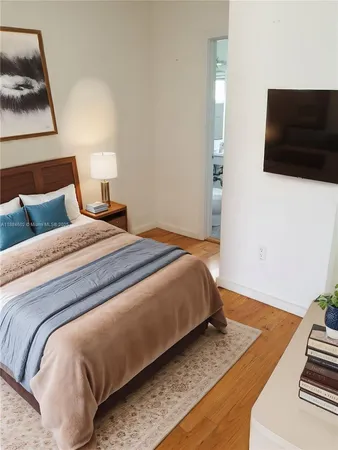 a bedroom with beds and a flat screen tv