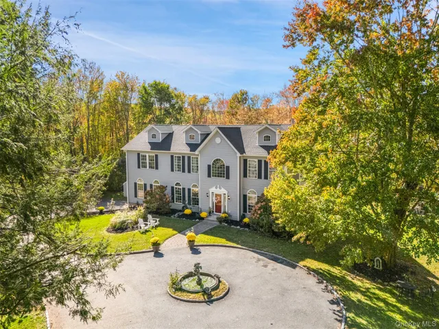 a view of a house with swimming pool and sitting area