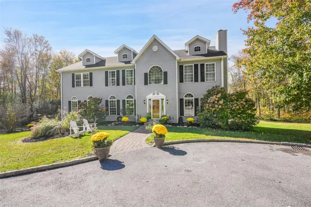 a front view of a house with swimming pool and porch
