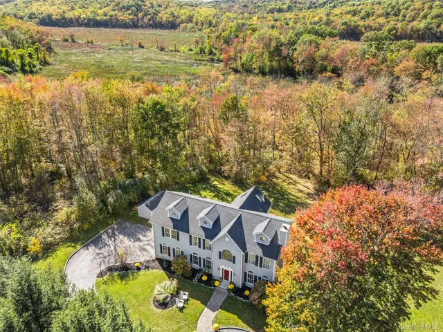 a view of a house with a yard porch and sitting area