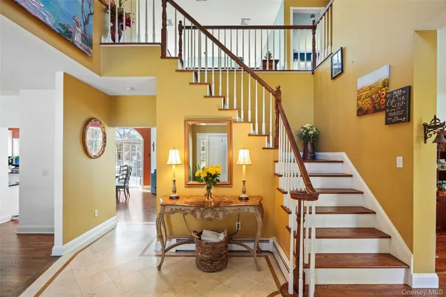a view of entryway and hall with wooden floor