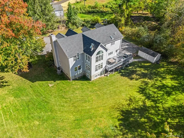 a front view of a house with a yard fire pit and outdoor seating