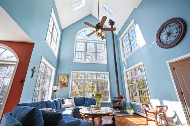 a living room with fireplace furniture and a large window