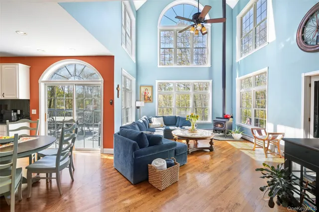 a living room with fireplace furniture and a large window
