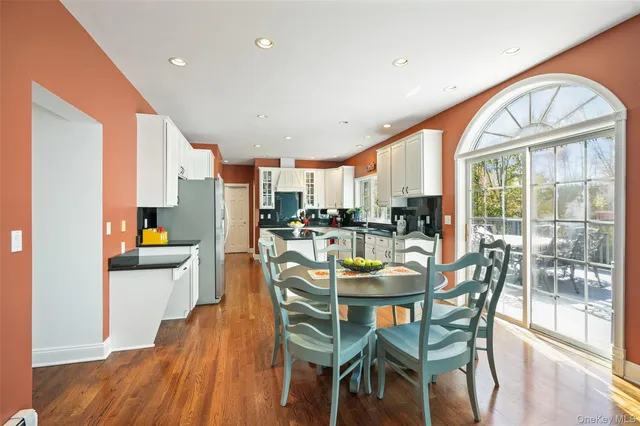 a dining room with furniture and wooden floor