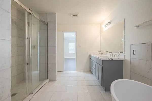 a bathroom with a granite countertop sink a toilet and shower
