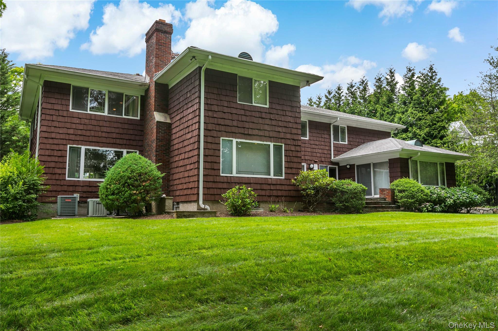 16 Meadow Road Scarsdale, NY 10583 - Photo 32 of 47 a front view of a house with a yard