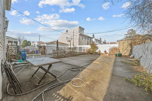 a view of a patio with a table and chairs