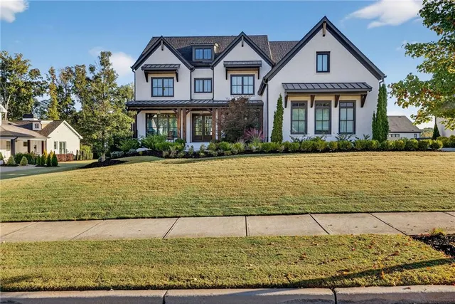 a front view of a house with a yard
