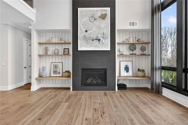 a kitchen with stainless steel appliances granite countertop a sink a stove and a wooden floors