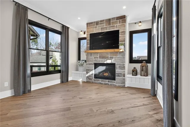a bath room with a toilet a sink and a mirror