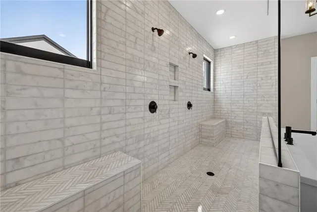 a bathroom with a bathtub sink vanity mirror and toilet