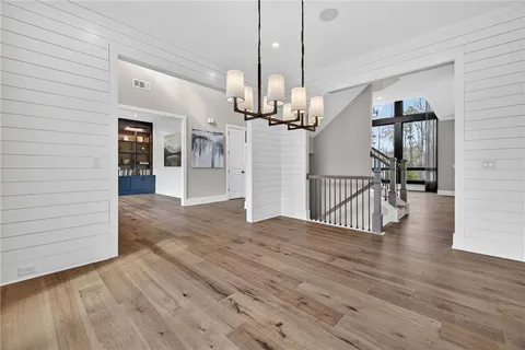 a view of a livingroom with wooden floor and a fireplace