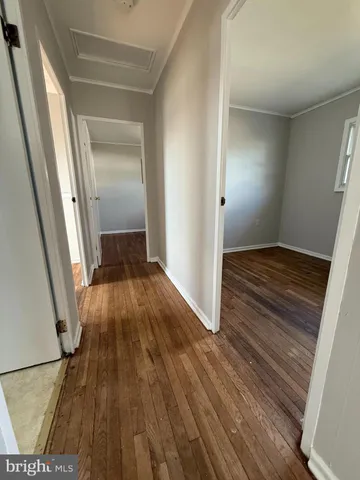 a view of a room with wooden floor and staircase