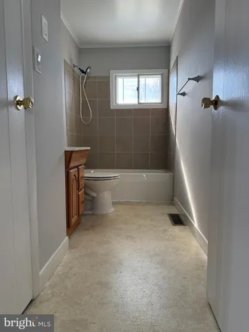 a bathroom with a bathtub a toilet and a shower