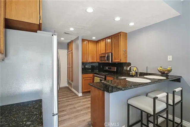 a kitchen with a sink cabinets and wooden floor