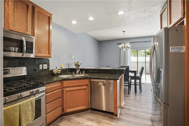 a kitchen with granite countertop a stove sink and cabinets
