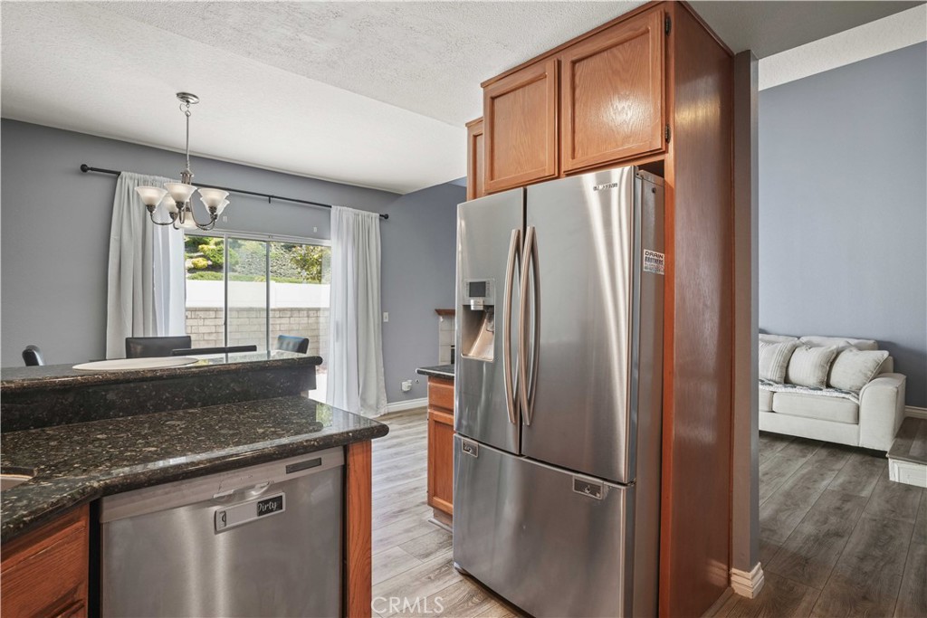 28345 Seco Canyon Road, Unit 97 Saugus, CA 91390 - Photo 14 of 38 a kitchen with granite countertop a refrigerator and a sink