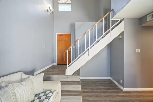 a view of entryway and hall with wooden floor