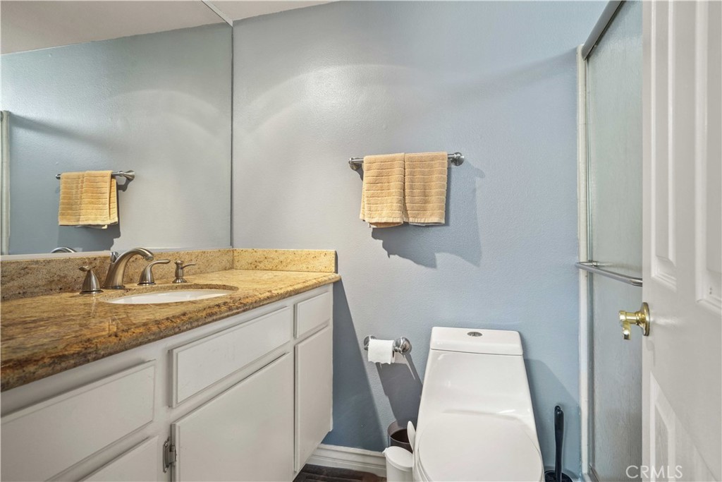 28345 Seco Canyon Road, Unit 97 Saugus, CA 91390 - Photo 21 of 38 a bathroom with a granite countertop sink and a mirror
