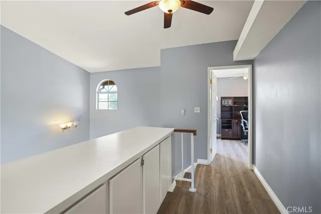 a hallway with a wooden floor and entryway