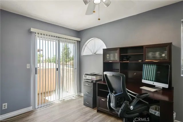 a workspace with wooden floor and a window