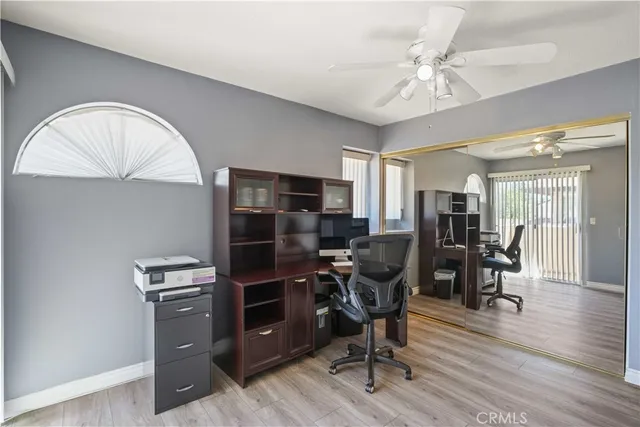 a view of a workspace with furniture and wooden floor