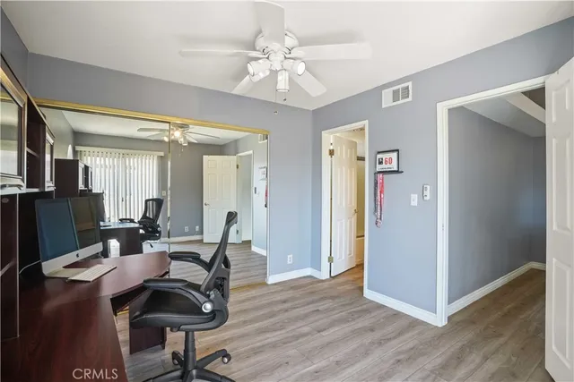 a view of a a dining room with furniture window and wooden floor