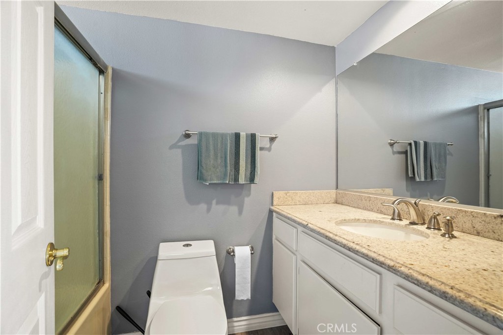 28345 Seco Canyon Road, Unit 97 Saugus, CA 91390 - Photo 27 of 38 a bathroom with a granite countertop sink and a mirror