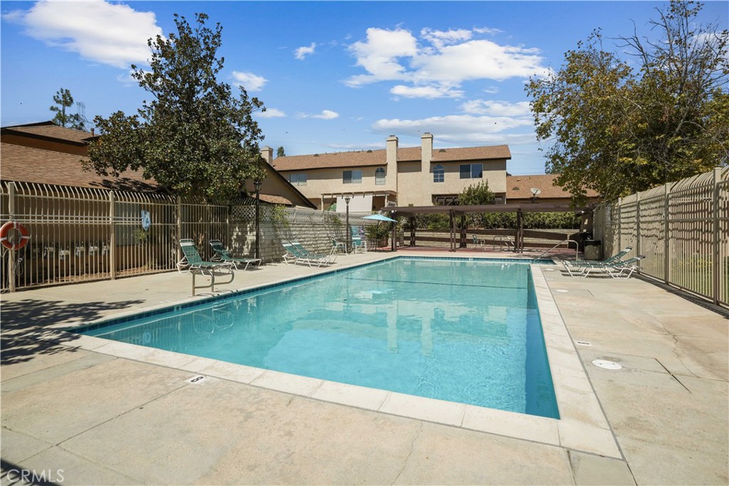 28345 Seco Canyon Road, Unit 97 Saugus, CA 91390 - Photo 31 of 38 a swimming pool with outdoor seating and yard
