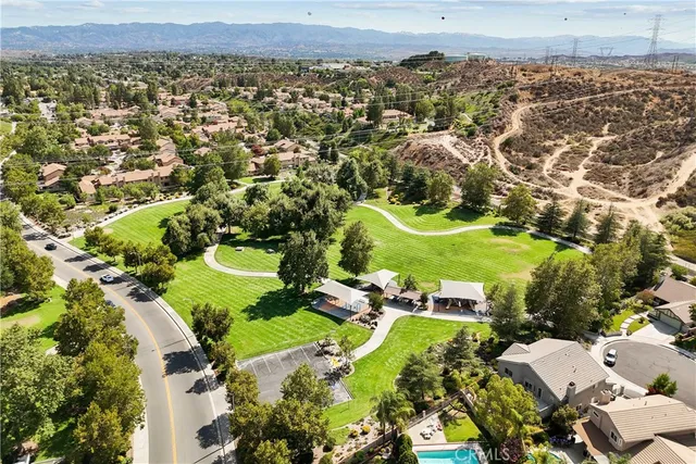 an aerial view of residential houses with city view