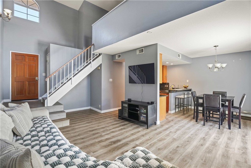 28345 Seco Canyon Road, Unit 97 Saugus, CA 91390 - Photo 7 of 38 a living room with furniture and a dining table with wooden floor