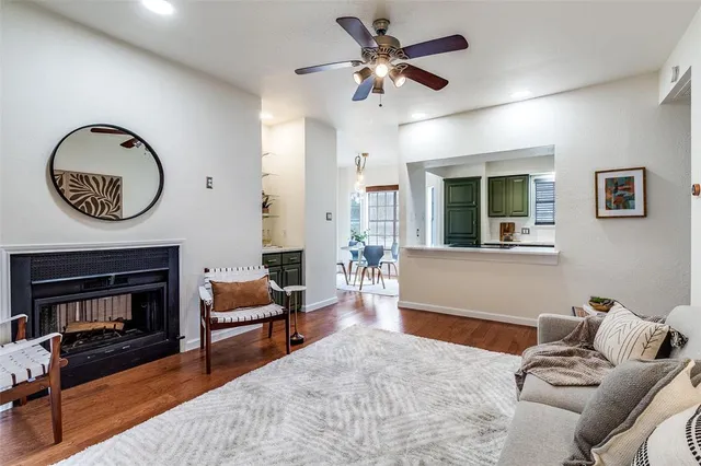 a living room with furniture a fireplace and a chandelier
